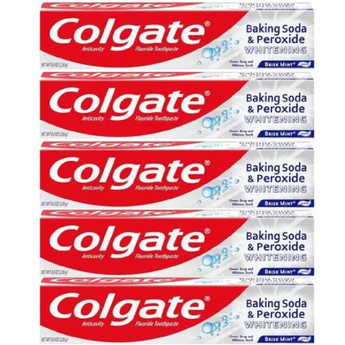 Multiple boxes of Colgate Baking Soda & Peroxide Whitening toothpaste stacked on a white background.