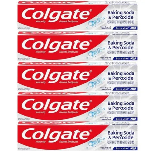 Multiple boxes of Colgate Baking Soda & Peroxide Whitening toothpaste stacked on a white background.