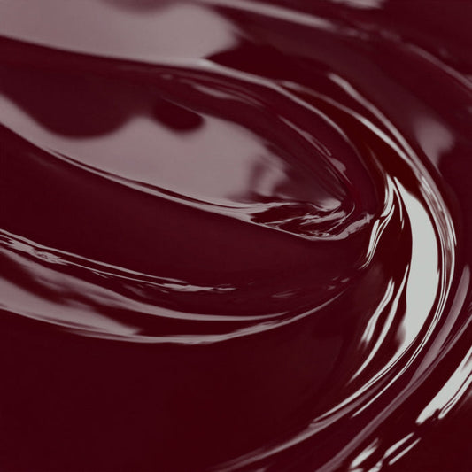 Close-up of a highly concentrated cranberry red liquid candle dye.