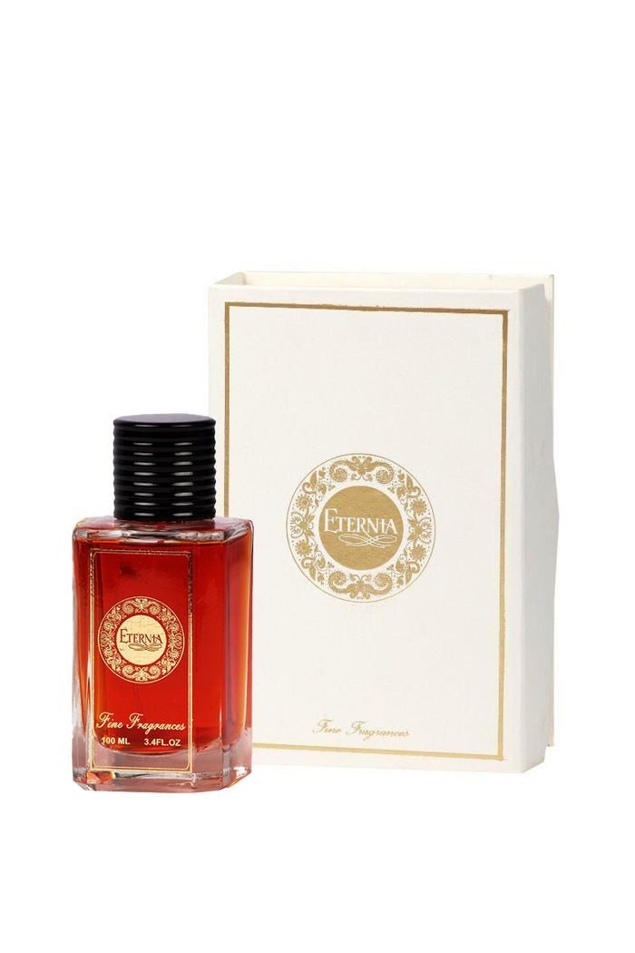 Eau de parfum bottle with red glass and black cap next to cream box