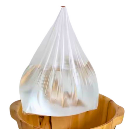 Z734A Pedicure Footbath Plastic Liners 50pc | Clear plastic bag filled with water over a wooden bowl on a white background