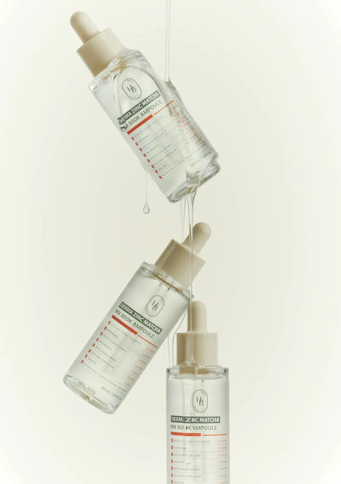 Three skincare serum bottles with droppers on a light beige background