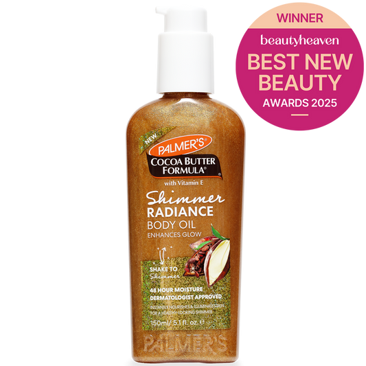 A bottle of Palmer's Cocoa Butter Formula Shimmer Radiance Body Oil with a white pump dispenser, shown on a white background with a pink Beauty Heaven Best New Beauty Awards 2025 badge in the top right corner.