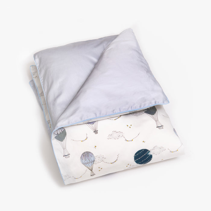 Baby duvet in the "Touch The Sky" print in the color blue