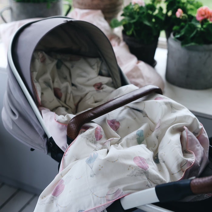 gooselings baby duvet in the print "Touch The Sky" in color pink laying in a stroller