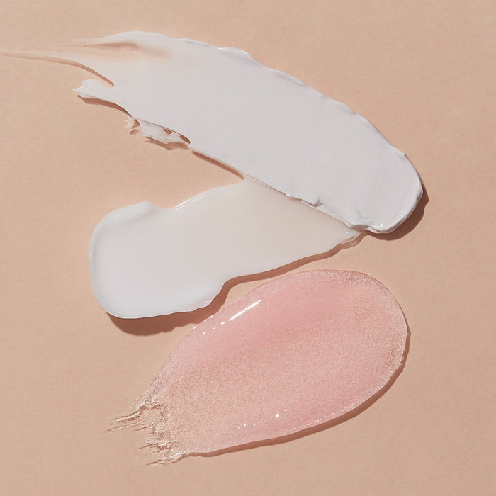 Two swatches of cream, one white and one pink, on a beige background